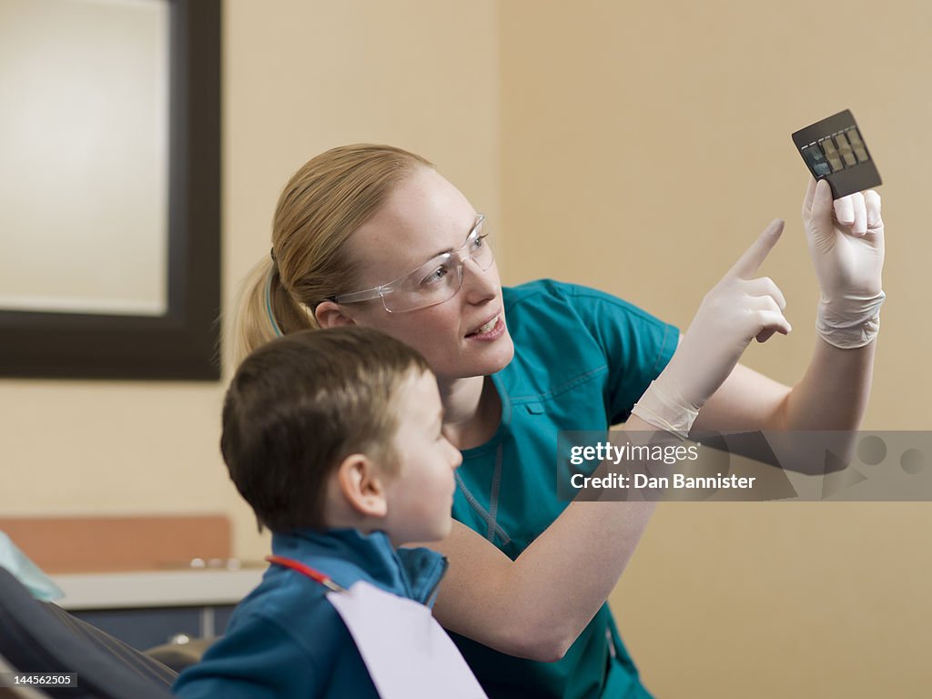Canada, Alberta, Dentists showing x-ray image to patient