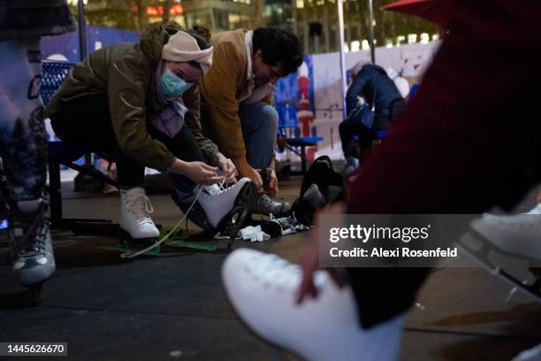 People lace up their ice skates after the Bank of America Winter Village Tree Lighting Ceremony at Bryant Park on November 29, 2022 in New York City.