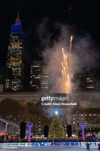 Fireworks explode as the Bryant Park Christmas Tree is lit up for the season at the Bank of America Winter Village Tree Lighting at Bryant Park with...