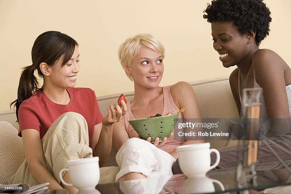 USA, California, Los Angeles, Three girlfriends relaxing on sofa