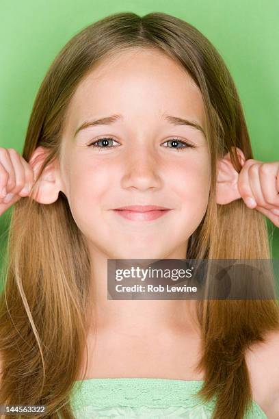 studio shot portrait of teenage girl pulling her ears, close-up - ear pulling stock pictures, royalty-free photos & images