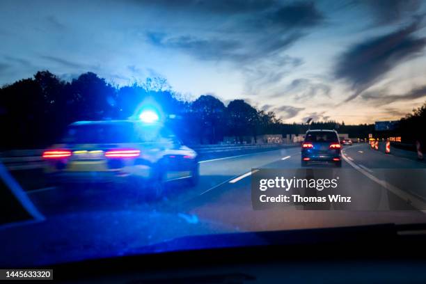 speeding police car on the freeway - polizist stock-fotos und bilder