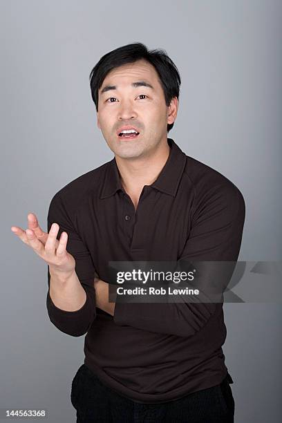 studio shot portrait of mature man gesturing, waist up - asian man studio shot stock pictures, royalty-free photos & images