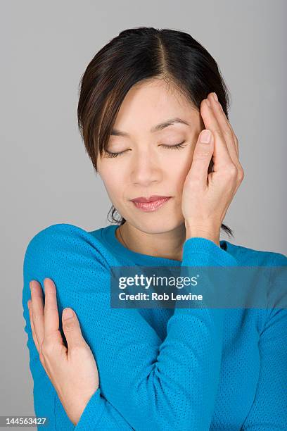 studio shot of vietnamese woman day dreaming - hair part stock pictures, royalty-free photos & images