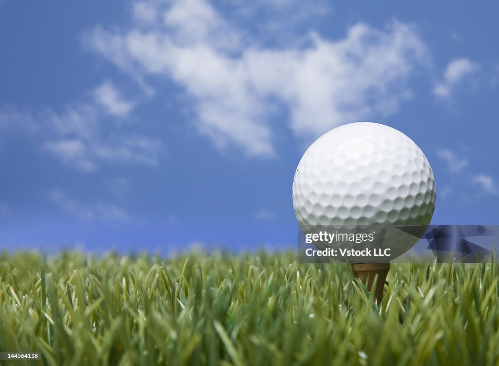 USA, Illinois, Metamora, Golf ball on tee under blue sky