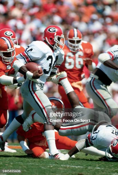 Running back Herschel Walker of the Georgia Bulldogs carries the ball against the Clemson Tigers during an NCAA football game circa 1981 at Memorial...