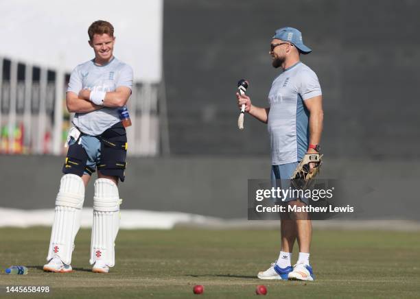 Brendon McCullum, Head Coach of England talks to Ollie Pope of England during a Net Session ahead of the First Test match at Rawalpindi Cricket...