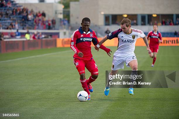 Patrick Nyarko of the Chicago Fire moves the ball up the field as Jonny Steele of Real Salt Lake defends at Toyota Park on May 9, 2012 in Bridgeview,...