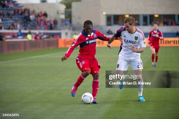 Patrick Nyarko of the Chicago Fire moves the ball up the field as Jonny Steele of Real Salt Lake defends at Toyota Park on May 9, 2012 in Bridgeview,...