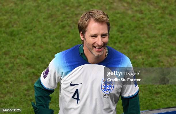 Singer Chesney Hawkes wearing a Declan Rice shirt smiles after the FIFA World Cup Qatar 2022 Group B match between Wales and England at Ahmad Bin Ali...