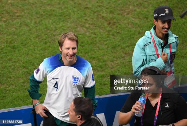 Singer Chesney Hawkes wearing a Declan Rice shirt smiles after the FIFA World Cup Qatar 2022 Group B match between Wales and England at Ahmad Bin Ali...