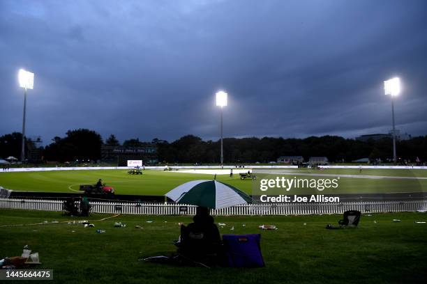 Fan watches on as rain delays play during game three of the One Day International series between New Zealand and India at Hagley Oval on November 30,...