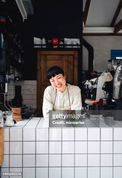 Portrait Of A Smiling Female Employee Working In A Coffee Shop