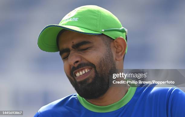 Babar Azam of Pakistan laughs during a training session before the first Test against England at Rawalpindi Cricket Stadium on November 30, 2022 in...