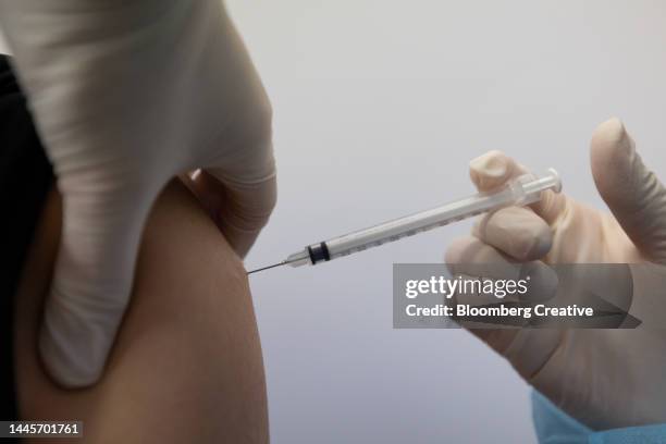 a healthcare worker administers a covid-19 vaccine - south korea vaccine stock pictures, royalty-free photos & images