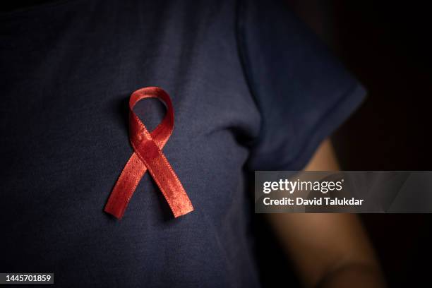 aids awareness red ribbon - virus hiv stock pictures, royalty-free photos & images