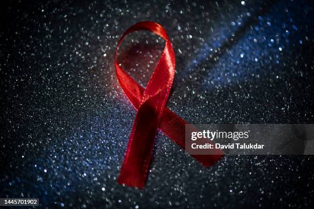 aids awareness red ribbon - world aids day stock pictures, royalty-free photos & images