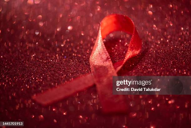 aids awareness red ribbon - world aids day stock pictures, royalty-free photos & images