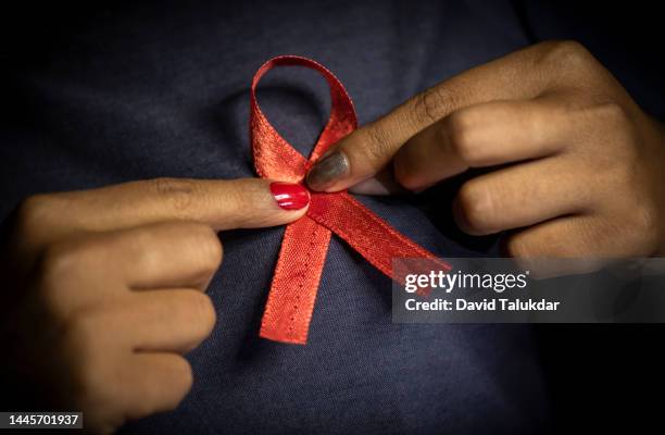 aids awareness red ribbon - world aids day stock pictures, royalty-free photos & images