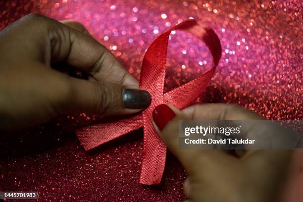 aids awareness red ribbon - world aids day stock pictures, royalty-free photos & images