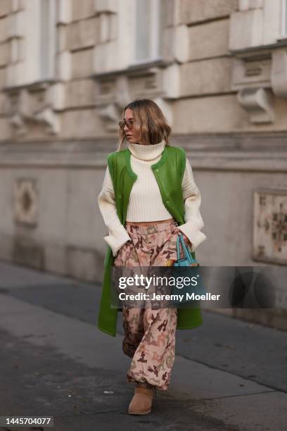 Karin Teigl is seen wearing Hermès Blue 32 leather Birkin bag, Gucci sunglasses, Lumina beige knit sweater, The Attico pants, Ugg beige ultra mini...