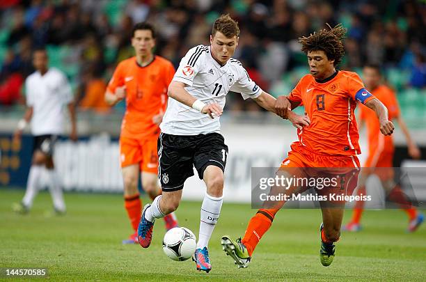 Maximilian Dittgen of Germany is challenged by Nathan Ake of Netherlands during the UEFA U17 European Championship game between Netherlands and...