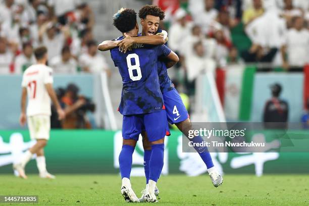 Weston McKennie and Tyler Adams of United States celebrate the team's first goal during the FIFA World Cup Qatar 2022 Group B match between IR Iran...