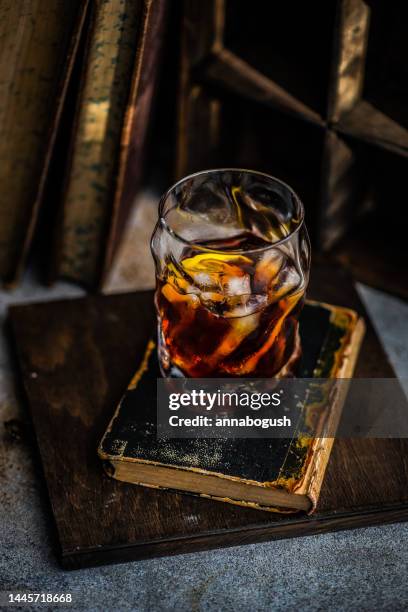 close-up of a vodka martini cocktail with old books on a table - old fashioned cocktail overhead stock pictures, royalty-free photos & images