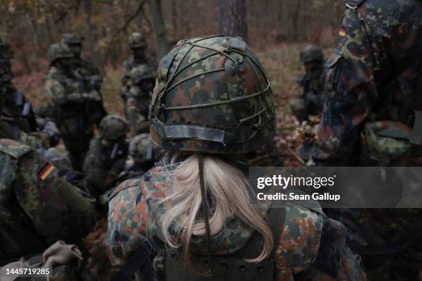 New female army recruit of the Bundeswehr, Germany's armed forces, participates in basic training in a forest on November 29, 2022 near Prenzlau,...