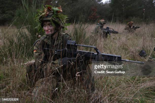 Female army recruit of the Bundeswehr, Germany's armed forces, is armed with a Heckler & Koch G36 assault rifle as she participates in basic training...
