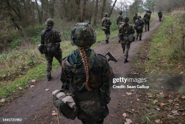 New female army recruit of the Bundeswehr, Germany's armed forces, participates in basic training in a forest on November 29, 2022 near Prenzlau,...