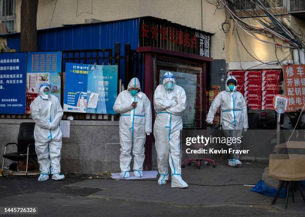 Security guards wear PPE to prevent the spread of COVID-19 as they guard a gate in an area with communities in lockdown and under health monitoring...