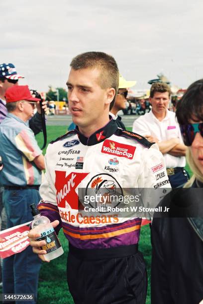 American race car driver Jeremy Mayfield walks toward the track at the Watkins Glen International raceway, Watkins Glen, New York, 1996.