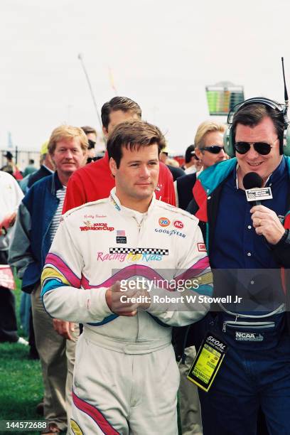 American race car driver Robby Gordon gives an interview before the Winston Cup Race at the Charlotte Motor Speedway, Charlotte, North Carolina, 1997.