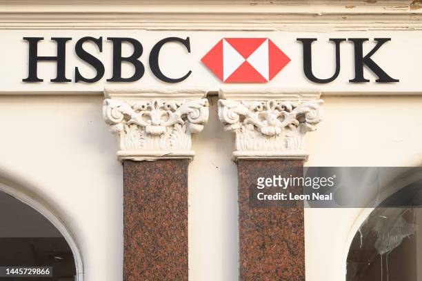 The HSBC logo is seen on signage outside a branch of the high-street bank on November 30, 2022 in London, England. The bank said footfall at its UK...