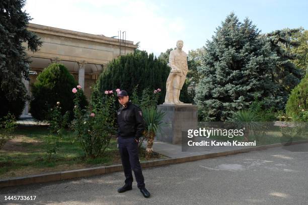 Museum guard stands in front of a statue of Georgian born Soviet leader Joseph Stalin displayed in the courtyard of Stalin Museum on October 17, 2022...