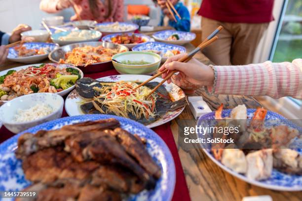 sharing their food - chinese new year food stock pictures, royalty-free photos & images