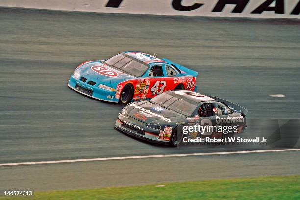 The Goodwrench Service and STP cars on the track during the Winston Cup Race at the Charlotte Motor Speedway, Charlotte, North Carolina, 1997.