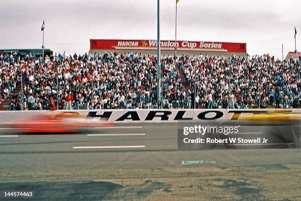 Unidentified cars speed along the track during the Winston Cup Race at the Charlotte Motor Speedway, Charlotte, North Carolina, 1997.