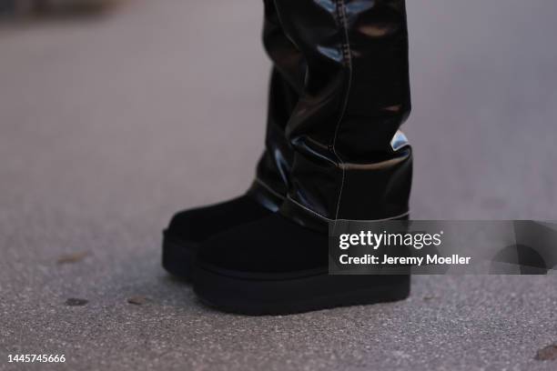 Karin Teigl is seen wearing H&M black vinyl leather pants and Ugg plateau/platform black boots, on November 25, 2022 in Vienna, Austria.