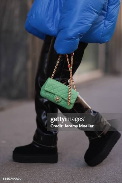 Karin Teigl is seen wearing Chanel light green bag, Gap x Yeezy blue puffer jacket, H&M black vinyl leather pants and Ugg plateau/platform black...