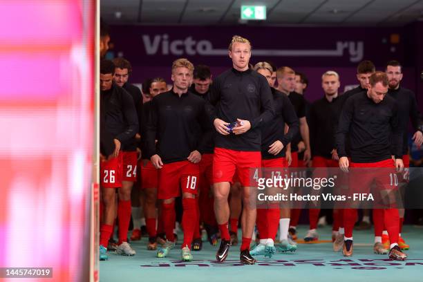 Simon Kjaer and Denmark players walk out for the warm up prior to the FIFA World Cup Qatar 2022 Group D match between Australia and Denmark at Al...