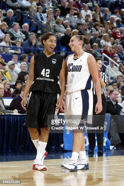 American basketball players Nykesha Sales and Diana Taurasi, both of the University of Connecticut, share a laugh during an exhibition game at the...