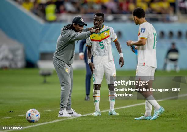 Head coach Aliou Cisse of Senegal speaks to Idrissa Gueye during the FIFA World Cup Qatar 2022 Group A match between Ecuador and Senegal at Khalifa...