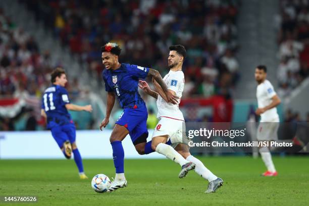 Weston McKennie of the United States under pressure from Saeid Ezatolahi of Iran during a FIFA World Cup Qatar 2022 Group B match between Iran and...