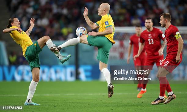 Jackson Irvine and Aaron Mooy of Australia collide during the FIFA World Cup Qatar 2022 Group D match between Australia and Denmark at Al Janoub...