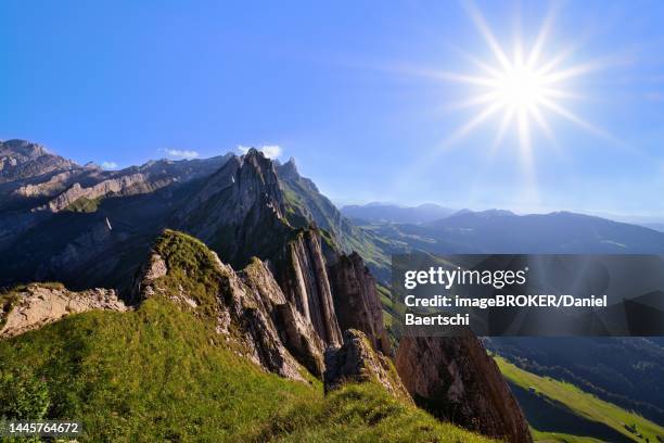 view of the alpstein mountains in appenzell, direct backlight with sun star in a cloudless sky, canton appenzell innerrhoden, switzerland - appenzell innerrhoden stock pictures, royalty-free photos & images