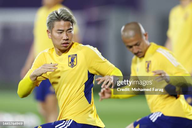 Takuma Asano of Japan stretches during the Japan Training Session at Al Sadd SC New Training Facilities on November 30, 2022 in Doha, Qatar.