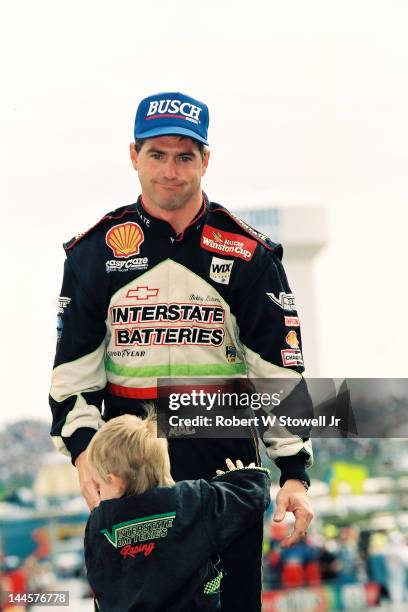 American race car driver Bobby LaBonte and a child at the Winston Cup Race at the Charlotte Motor Speedway, Charlotte, North Carolina, 1997.