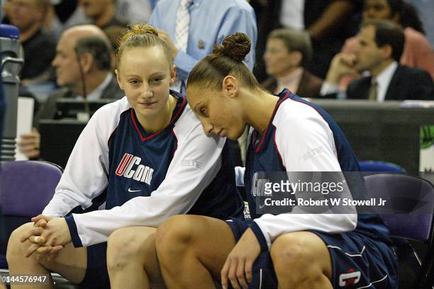 American basketball players Maria Conlon and Diana Taurasi, both of the University of Connecticut, sit together on the bench prior to the to the 2004...